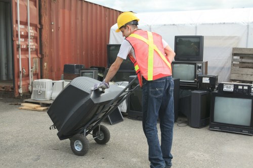 Workers preparing a load of renovation waste for transport